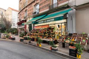 a store with flowers and plants in front of a street at Le Cocon - 5 min RER A - 10 min Paris in Fontenay-sous-Bois