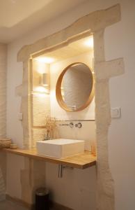 a bathroom with a sink and a mirror on a counter at Domaine Cap Rubis in Paradou