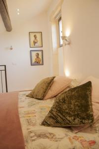 a bedroom with a bed with two pillows on it at Domaine Cap Rubis in Paradou