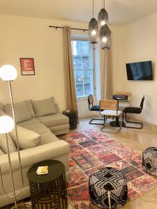 a living room with a couch and a table at Leith Street Suite in Edinburgh