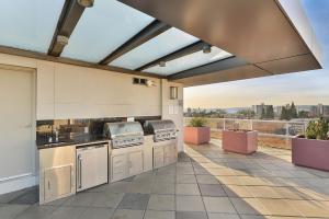 an outdoor kitchen with a view of the city at Duet Executive Stay in Victoria