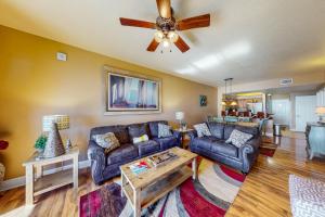 a living room with couches and a ceiling fan at Ariel Dunes I 1709 in Destin