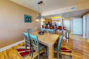 a dining room with a wooden table and chairs at Ariel Dunes I 1709 in Destin