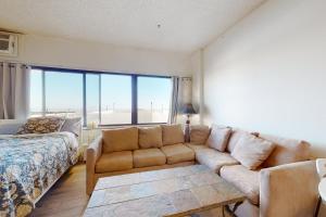 a living room with a couch and a bed at Highpoint North M1 in Ocean City