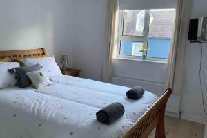 a bedroom with a bed with two pillows on it at Bumblebee Cottage in Donegal