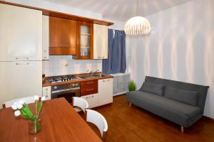 a kitchen and living room with a table and a couch at San Siro-duomo WI-FI & Netflix in Milan
