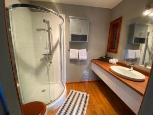 a bathroom with a shower and a sink at L'enchantement Vacation home by Rendez-Vous Mont-Tremblant in Mont-Tremblant