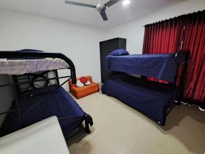 a room with three bunk beds and a window at CASA CAMPESTRE LA ESMERALDA in Melgar