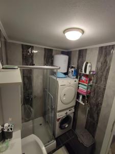 a small bathroom with a shower and a toilet at Stan na dan Apartman KRISFIL Prnjavor in Prnjavor +49 photos
