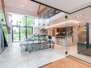 a kitchen with glass walls and a dining room at Home Barn in Lyminge