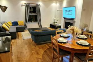 a living room with a table and a couch at Stunning Luxury 2 Bed Penthouse Apartment in Derby