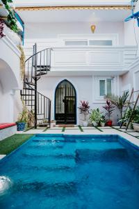 a swimming pool in front of a house at Najma's villa in Stone Town