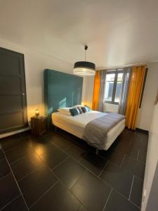 a bedroom with a bed and a large window at Home Cassis - Maison Les Calanques - Piscine chauffée in Cassis