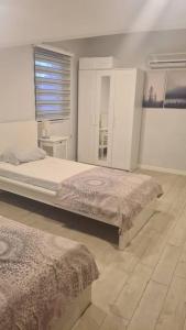 a bedroom with two beds and a window at Mountainview residency in Belek