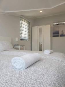 a white bed with two pillows on top of it at Mountainview residency in Belek