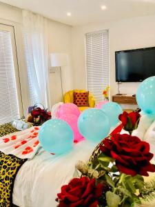 a room with a bed with balloons and roses at MeeZee Pearl Double Bed Lodge With Free Parking in Manchester