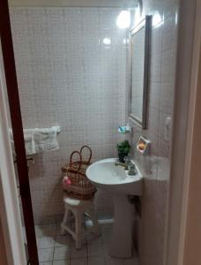 a bathroom with a sink and a toilet and a mirror at Departamento en Ramallo in Ramallo
