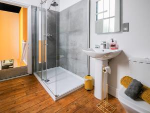 a bathroom with a shower and a sink at The Gold Apartment - UK40025 in Southport