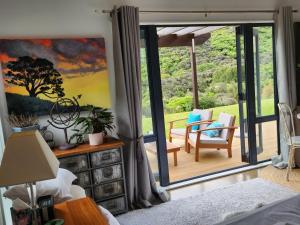 a bedroom with a large sliding glass door with a patio at Boutique Art Retreat in Upper Hutt