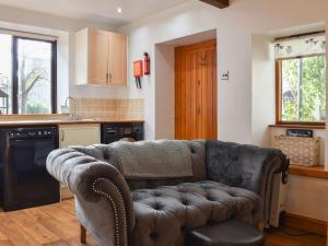 a living room with a couch in a kitchen at Pear Tree Barn in Crooklands