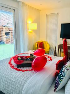 a bedroom with a bed with red decorations on it at MeeZee Pearl Double Bed Lodge With Free Parking in Manchester