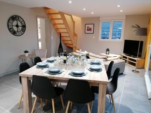 a dining room with a table and chairs at Les Catèdjes in Fraize