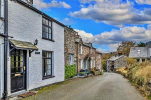 an empty street in a village with stone houses at Finest Retreats - Harp House in Dolwyddelan