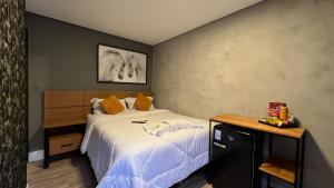Cama ou camas em um quarto em Hotel La Serena