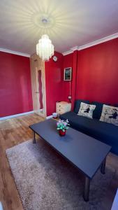 a living room with a blue couch and a table at Palaz 6 - 2 bedroom flat in Edmonton