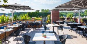 an outdoor patio with tables and chairs and umbrellas at The Saint James Hotel, Ascend Hotel Collection in Toronto