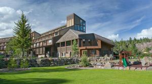 a large building with a stone wall at Tamarron Lodge Studio 343 in Durango