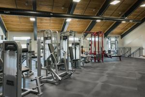 a gym with several tread machines and a person in the background at Tamarron Lodge Studio 343 in Durango