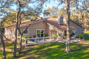 a house with a large deck in the yard at King Bed in Relaxing Oasis, with FREE Snack/Wi-Fi/Parking in San Marcos