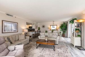 a living room with a couch and a table at Gorgeously remodeled 2 bedroom ocean front unit - 509 South Hampton condo in Myrtle Beach
