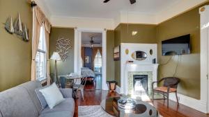 a living room with a couch and a fireplace at The Jepson Estate on Forsyth Park! in Savannah
