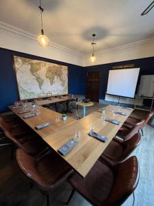 a large conference room with a large table and a screen at The Blue Piano Guesthouse in Birmingham