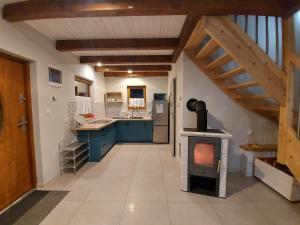 a kitchen with a stove in the middle of a room at Domek u Beti in Wąglikowice