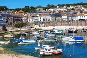 a bunch of boats are docked in a harbor at Idyllic Cornish cottage in the beautiful Lamorna valley - walk to pub & sea in Paul