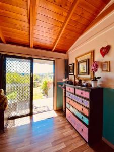 a room with a dresser and a sliding glass door at The Bohemian Art Studio in Creswick