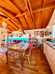 a kitchen with a table and a wooden ceiling at The Bohemian Art Studio in Creswick