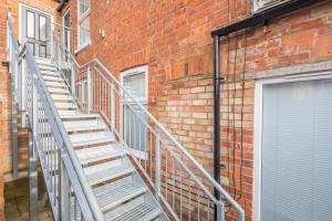 a set of stairs next to a brick building at Cosy Two bed Apartment for family and contractors Milton Keynes by O&J Real Estate in Milton Keynes