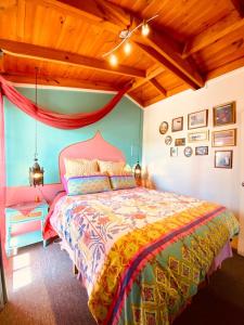 a bedroom with a bed and a wooden ceiling at The Bohemian Art Studio in Creswick