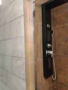 a shower with a phone in a bathroom at Gonnelles Appartement T3 Centre Ville RDC D in Agen