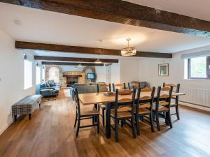 a dining room with a wooden table and chairs at The Barn House in Hawes