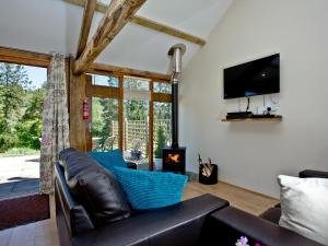 a living room with a couch and a fireplace at Bluetit Cottage in Kings Nympton