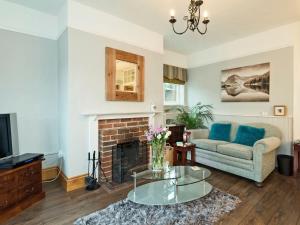 a living room with a couch and a fireplace at Horseshoe House - Ukc2743 in Watton