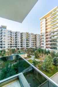 an apartment balcony with a view of a park at Luxury Pipera in Voluntari