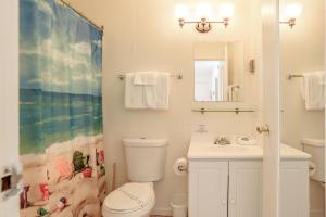 a bathroom with a toilet and a sink and a mirror at Green Acres Lakeside Resort Salt Spring Island in Ganges