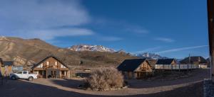 a group of buildings with mountains in the background at Los Molles Complejo Turistico in Los Molles