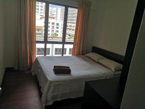 a bed in a room with a large window at Homestay Marina Court Kota Kinabalu Sabah in Kota Kinabalu